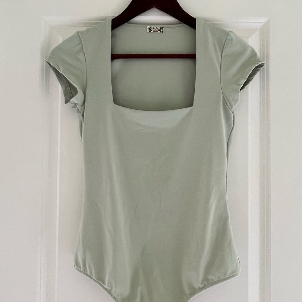 Free people light green body suit in size XS.